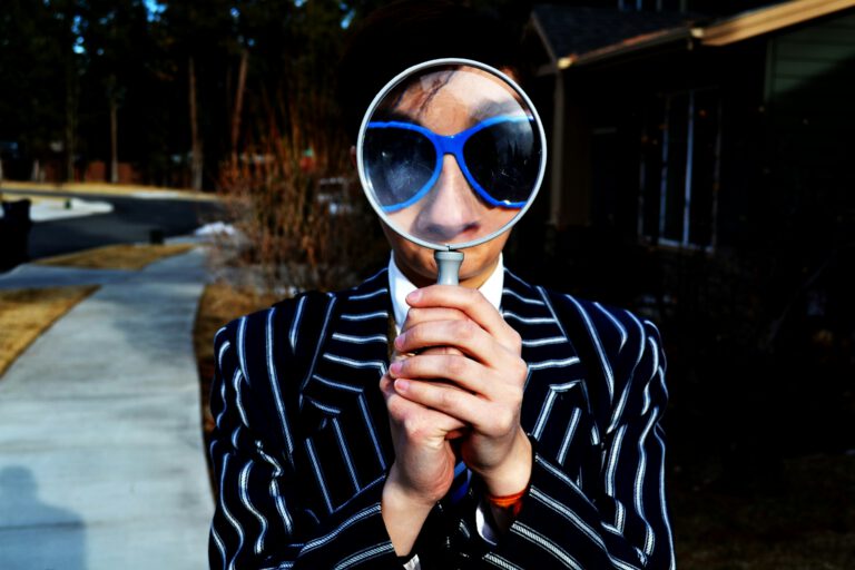 person searching holding looking glass